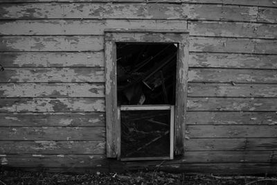 Detail view of small derelict house in a wooded area