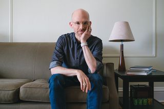 David Sleight sitting on a couch facing the viewer