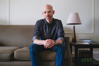 David Sleight sitting on a couch facing the viewer