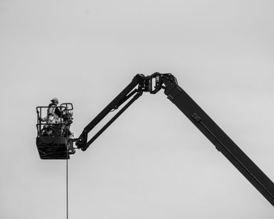 Workmen in a construction crane basket