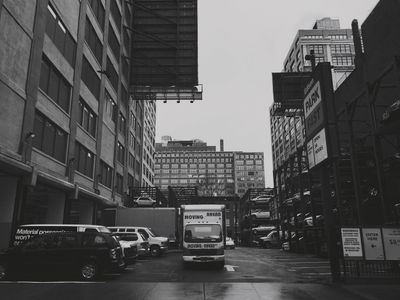 Truck parked in center of narrow urban parking lot