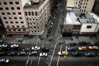 View looking down at busy city street filled with cars